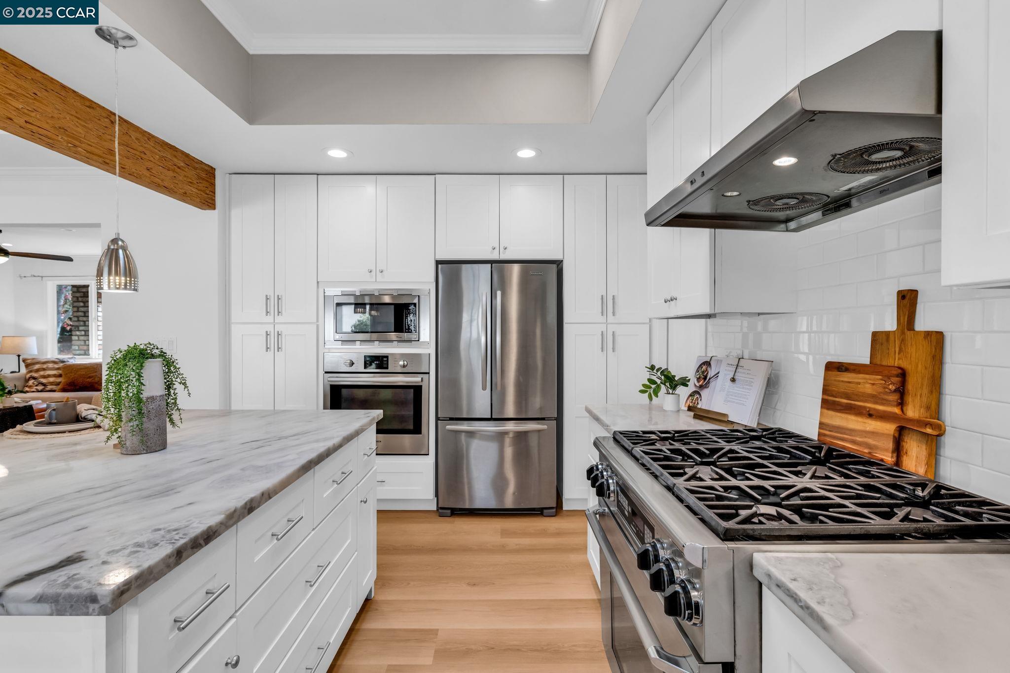 4597 Wildcat Lane Concord, CA 94521 - Photo 17 of 57 a kitchen with granite countertop stainless steel appliances a counter space and cabinets