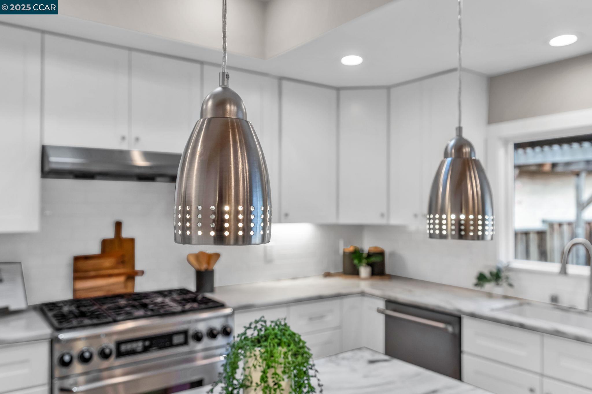 4597 Wildcat Lane Concord, CA 94521 - Photo 20 of 57 a kitchen with kitchen island granite countertop a stove and a sink