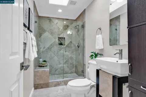 a bedroom with a bed a flat screen tv and a large window with the garden view