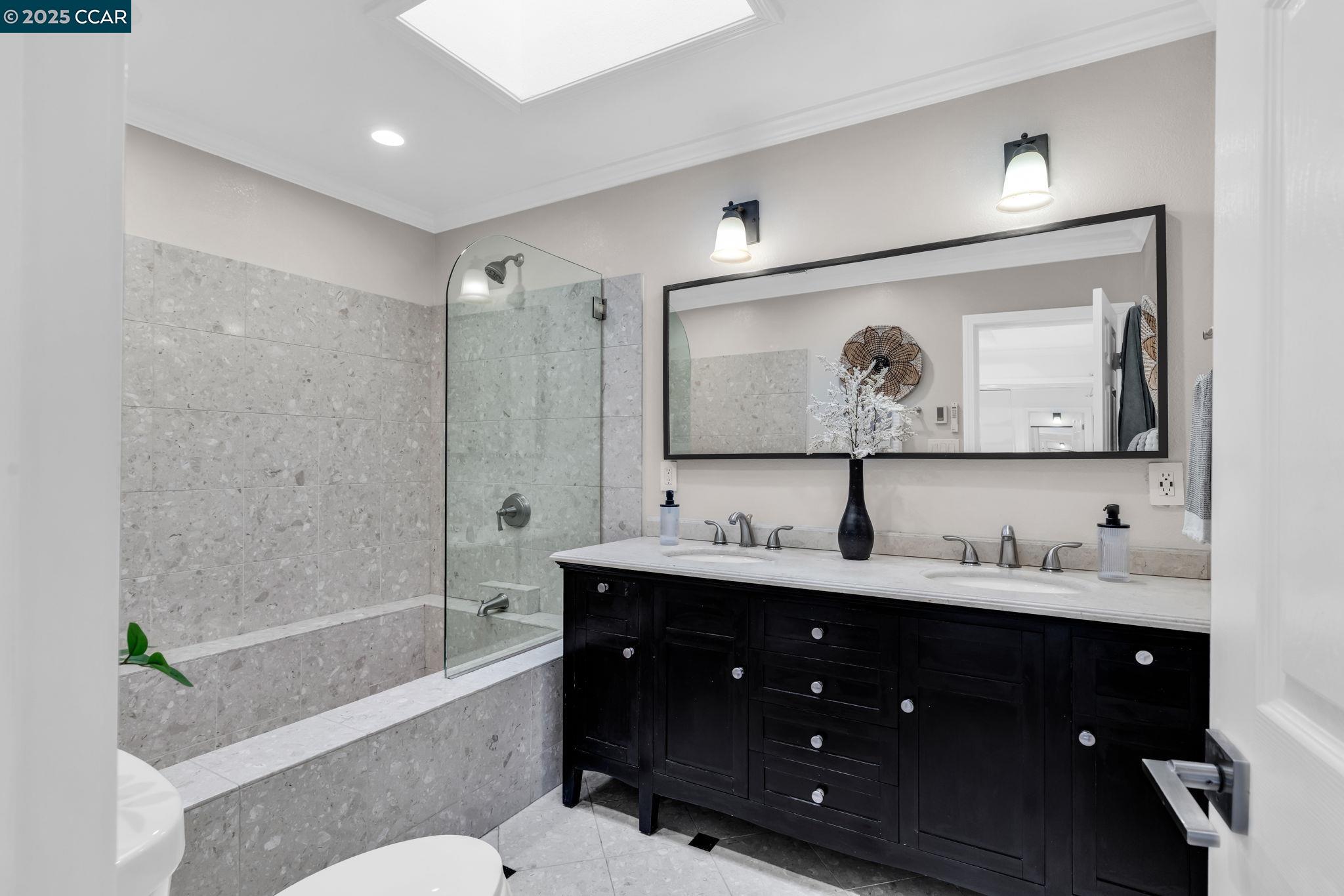 4597 Wildcat Lane Concord, CA 94521 - Photo 29 of 57 a bathroom with a double vanity sink mirror double and bathtub