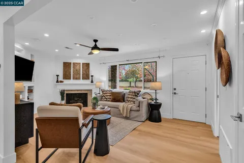a living room with fireplace furniture and a flat screen tv