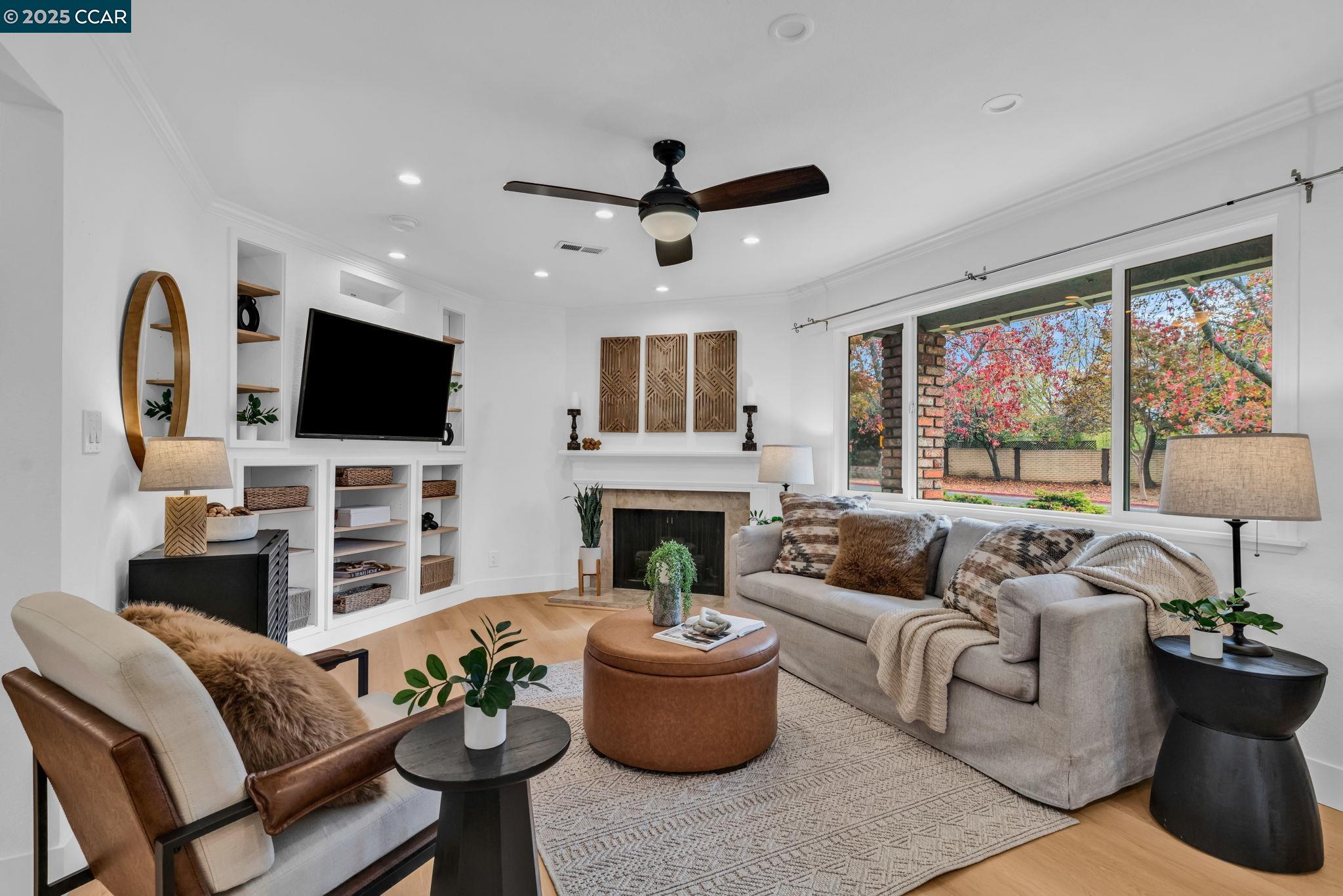 4597 Wildcat Lane Concord, CA 94521 - Photo 6 of 57 a living room with furniture a fireplace and a flat screen tv