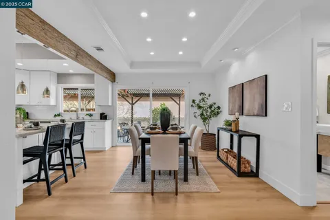 a view of a dining room with furniture and window