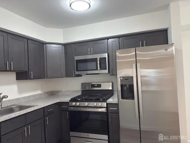a kitchen with a refrigerator stove and microwave