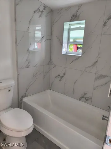 a bathroom with a toilet and a bathtub