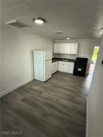 a kitchen with stainless steel appliances wooden cabinets and empty counter top space