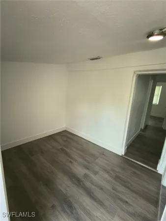 a view of an empty room and wooden floor