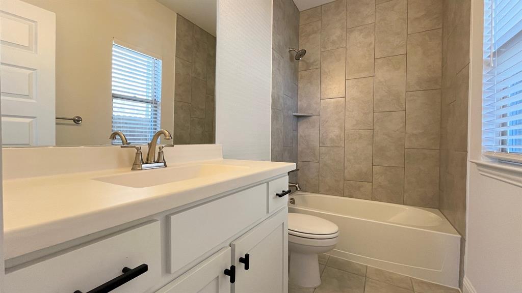 5304 Babcock Road McKinney, TX 75071 - Photo 24 of 27 a bathroom with a sink a toilet and shower