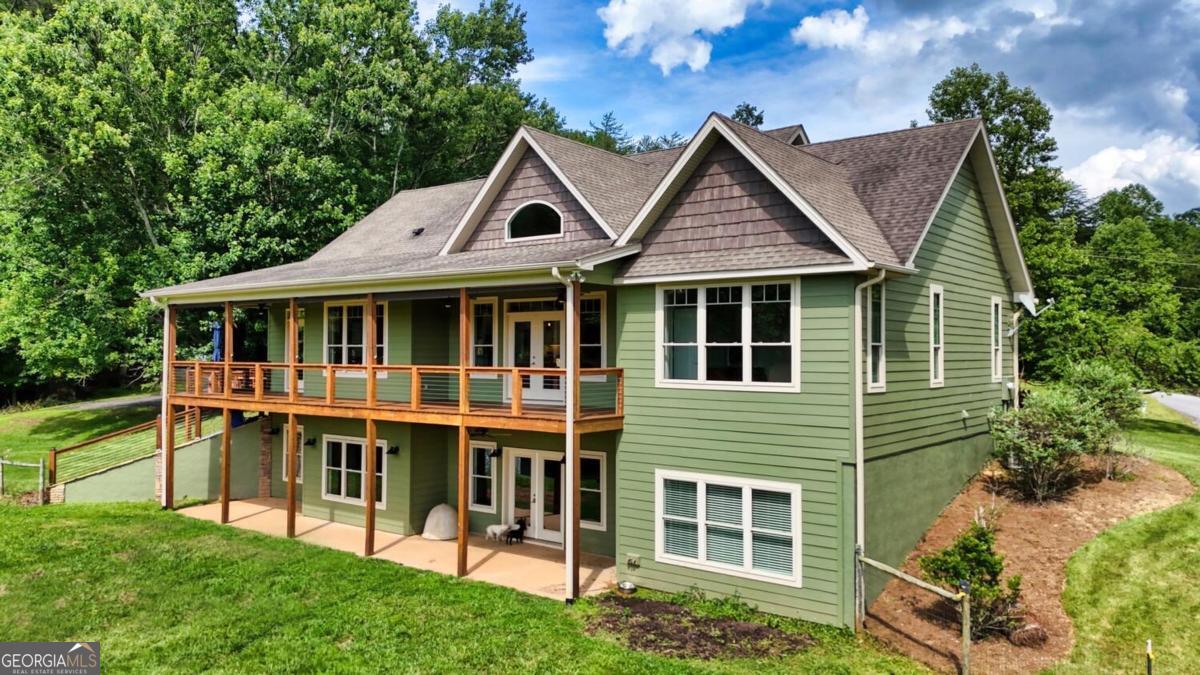 583 Fleenor Road, Unit TR 1 2 3 Blairsville, GA 30512 - Photo 22 of 99 a view of a house with a yard and potted plants