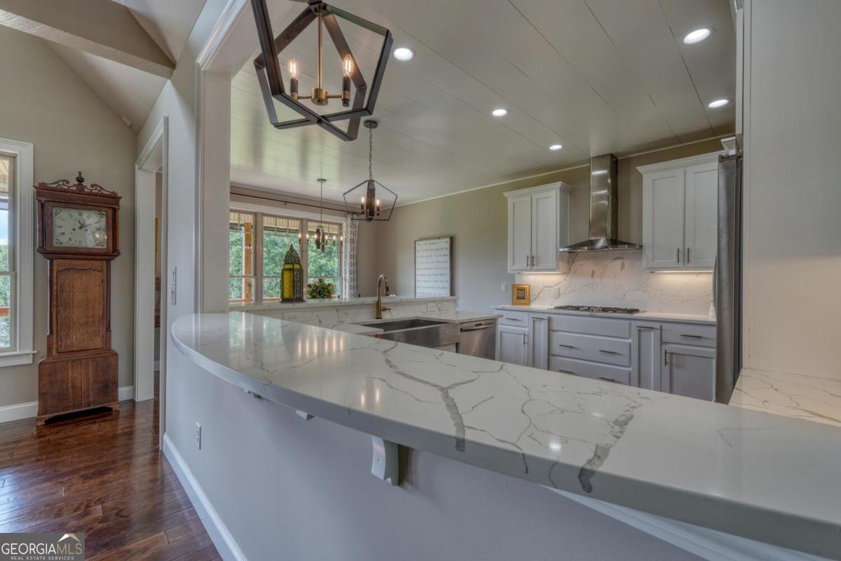 583 Fleenor Road, Unit TR 1 2 3 Blairsville, GA 30512 - Photo 33 of 99 a large kitchen with kitchen island a large counter space a sink a window and stainless steel appliances