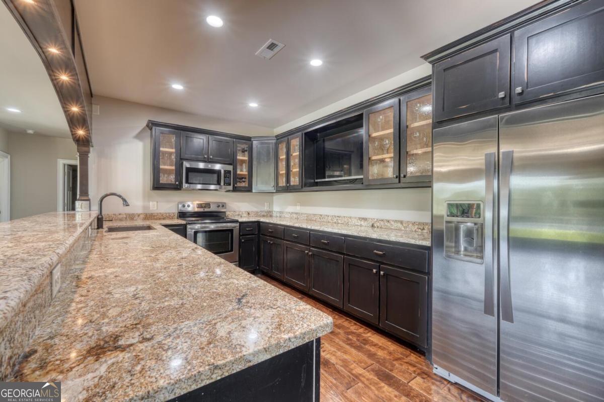 583 Fleenor Road, Unit TR 1 2 3 Blairsville, GA 30512 - Photo 56 of 99 a large kitchen with stainless steel appliances granite countertop a sink and a refrigerator