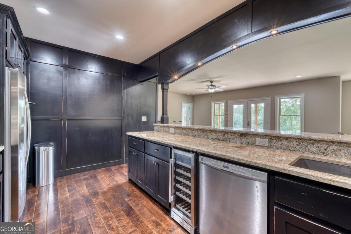 583 Fleenor Road, Unit TR 1 2 3 Blairsville, GA 30512 - Photo 58 of 99 a bathroom with a granite countertop sink a large mirror and a shower