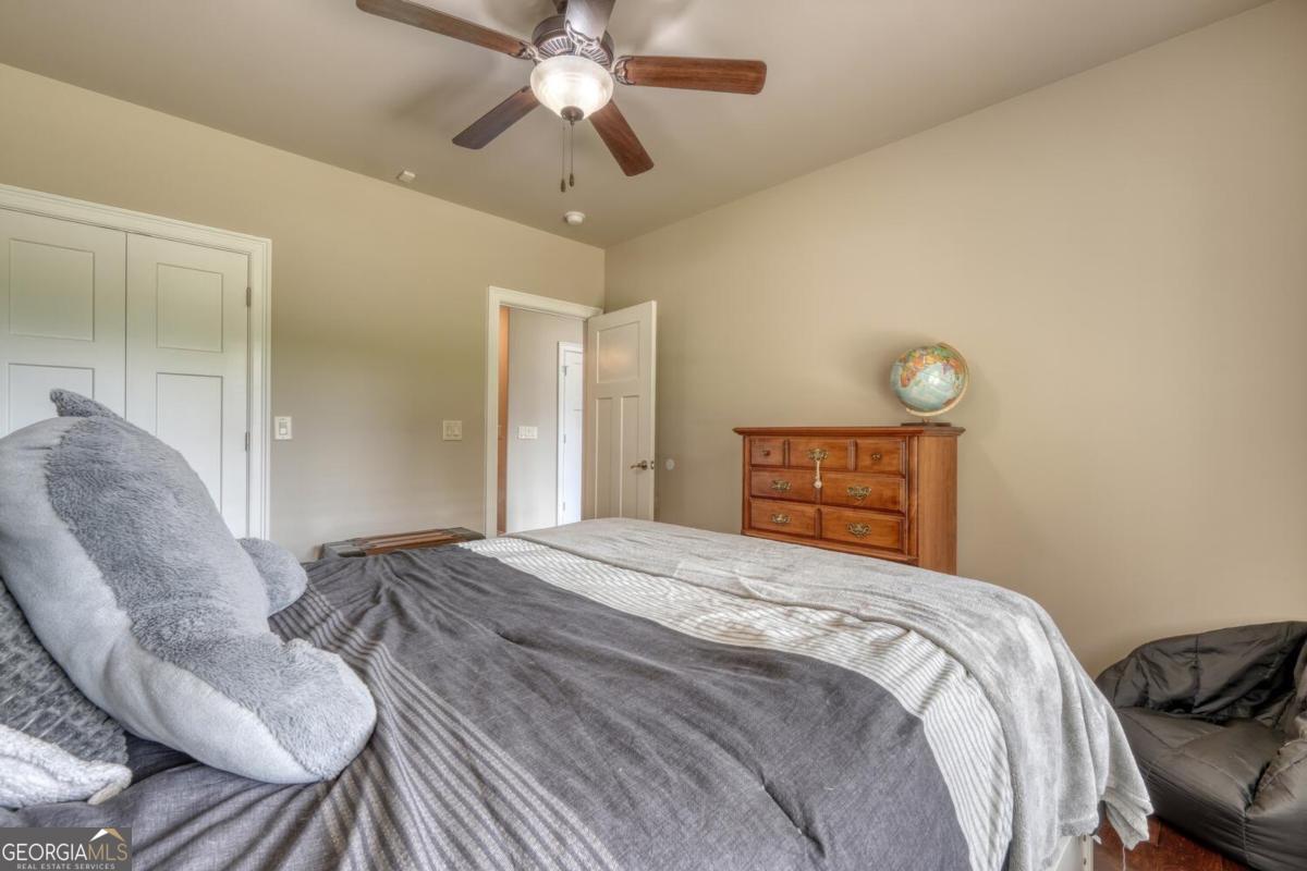 583 Fleenor Road, Unit TR 1 2 3 Blairsville, GA 30512 - Photo 63 of 99 a bedroom with a bed and a chandelier