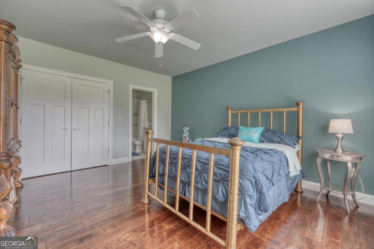 583 Fleenor Road, Unit TR 1 2 3 Blairsville, GA 30512 - Photo 66 of 99 a spacious bedroom with a bed and a chandelier