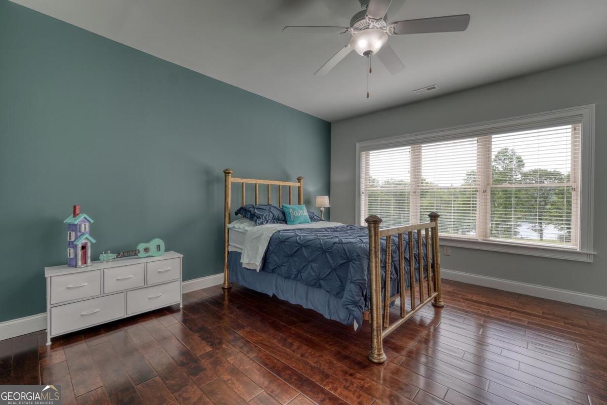 583 Fleenor Road, Unit TR 1 2 3 Blairsville, GA 30512 - Photo 67 of 99 a bedroom with a bed and a chandelier fan