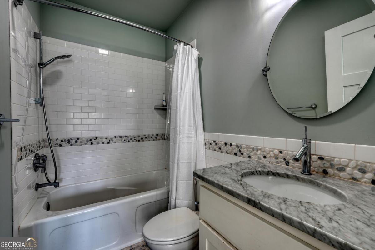 583 Fleenor Road, Unit TR 1 2 3 Blairsville, GA 30512 - Photo 69 of 99 a bathroom with a granite countertop sink a toilet and shower