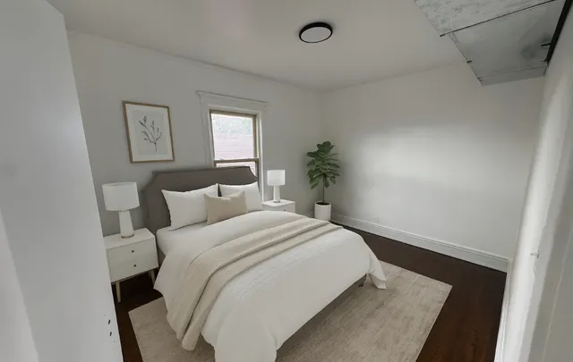 a bedroom with a bed and painting on the wall