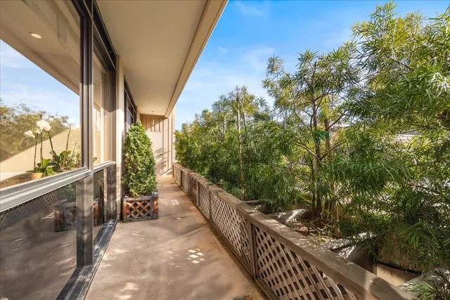 a view of a balcony with wooden fence