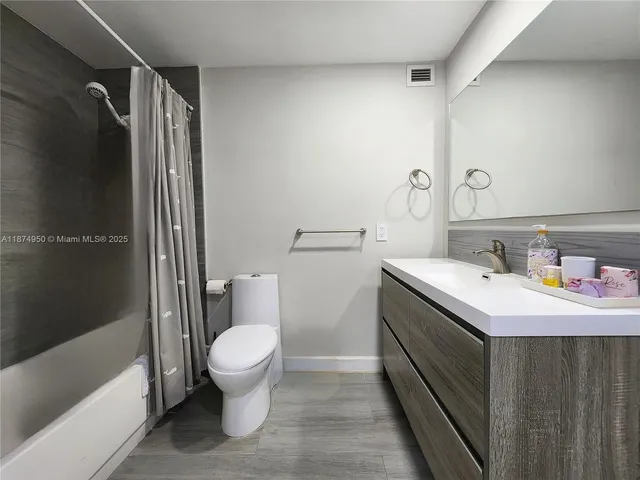 a bedroom with a bed and a night stand