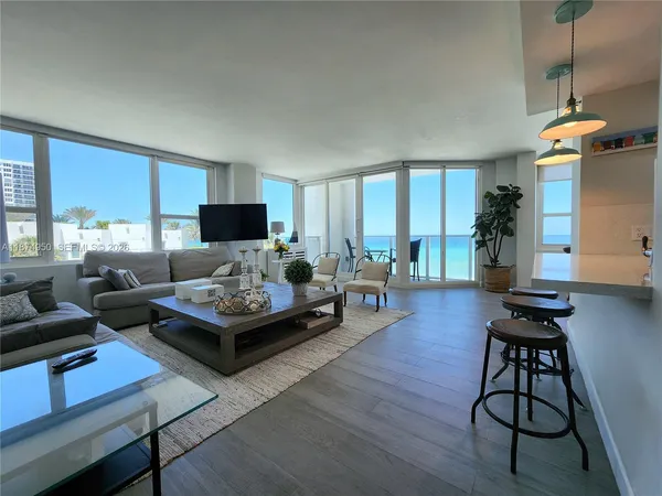 a kitchen with sink refrigerator and dining table