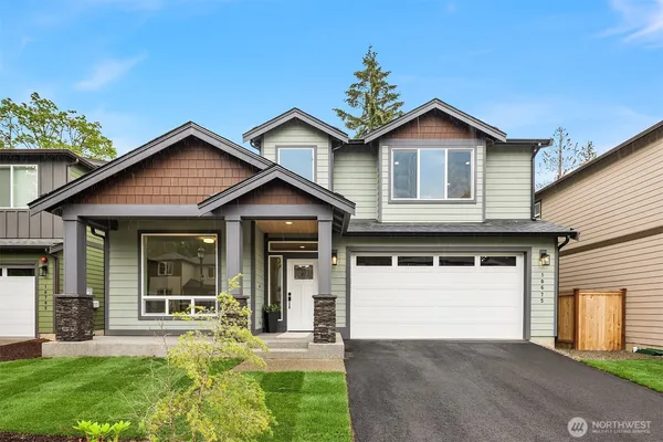 a front view of a house with a yard and garage