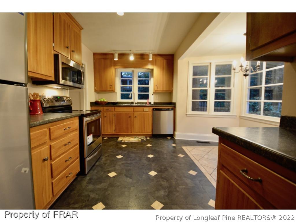 606 Rush Road Fayetteville, NC 28305 - Photo 11 of 22 a kitchen with stainless steel appliances granite countertop a sink stove and cabinets