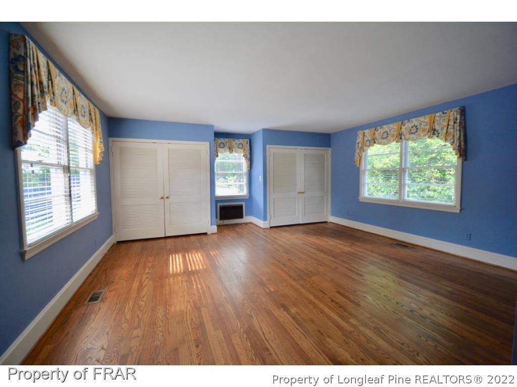 606 Rush Road Fayetteville, NC 28305 - Photo 16 of 22 a view of an empty room with wooden floor and a window