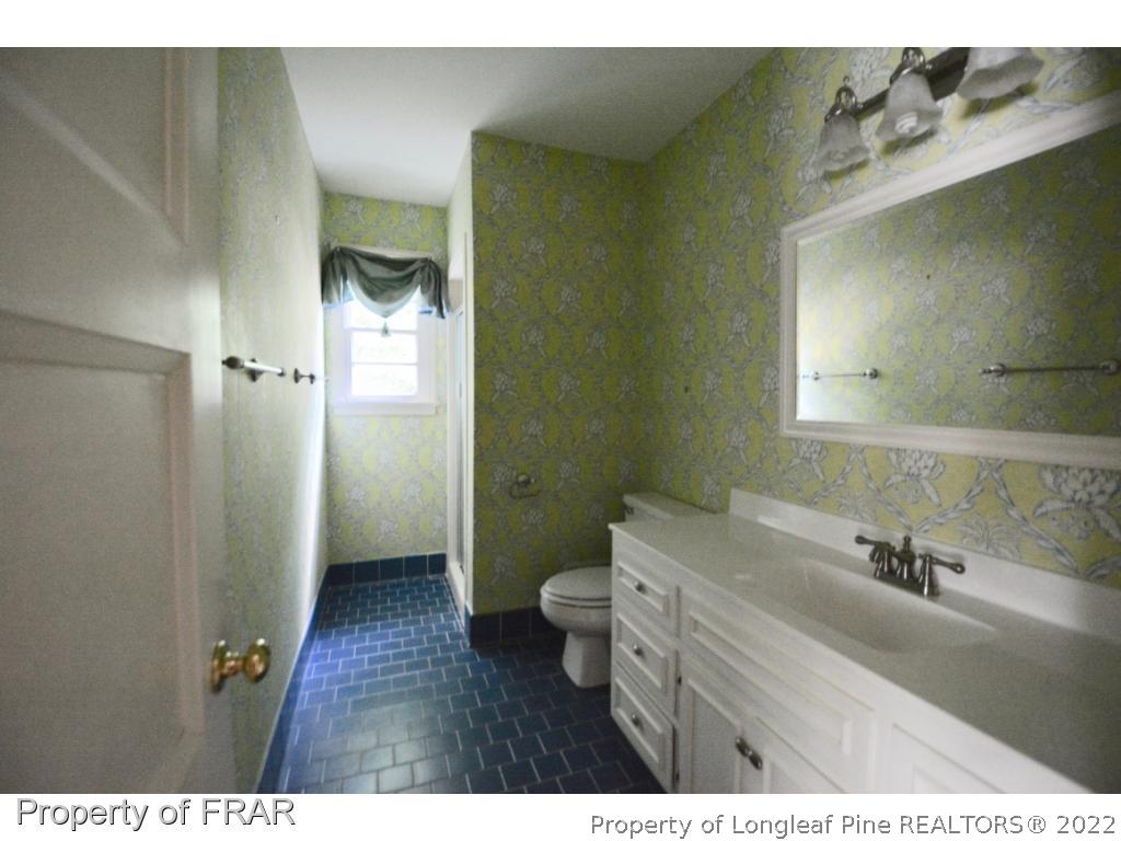 606 Rush Road Fayetteville, NC 28305 - Photo 19 of 22 a bathroom with a sink a toilet and shower