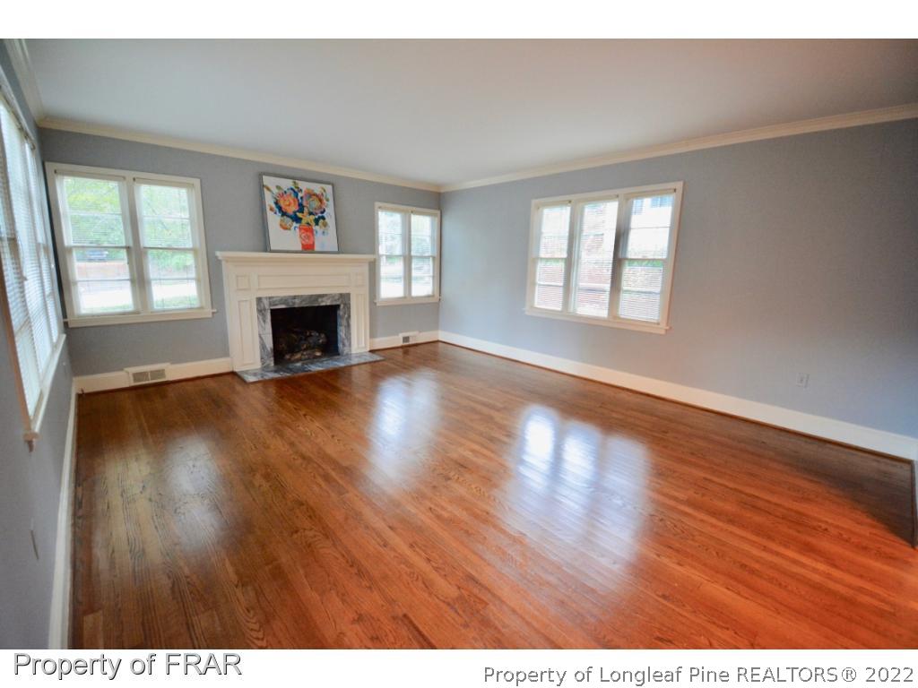 606 Rush Road Fayetteville, NC 28305 - Photo 3 of 22 a view of empty room with wooden floor and fireplace