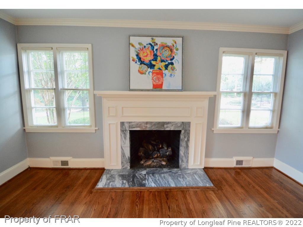 606 Rush Road Fayetteville, NC 28305 - Photo 5 of 22 a living room with a fireplace and wooden floor