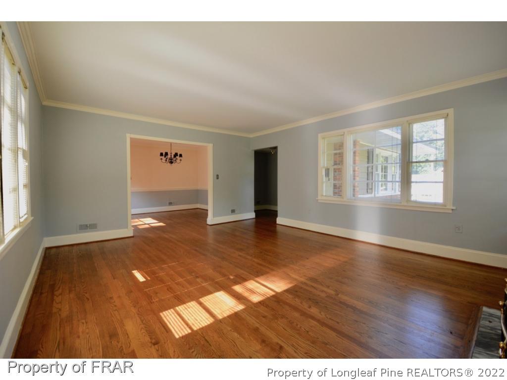 606 Rush Road Fayetteville, NC 28305 - Photo 6 of 22 an empty room with wooden floor and windows