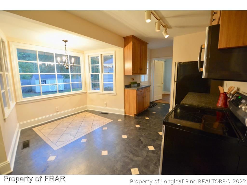 606 Rush Road Fayetteville, NC 28305 - Photo 9 of 22 a living room with a floor to ceiling window and a flat screen tv