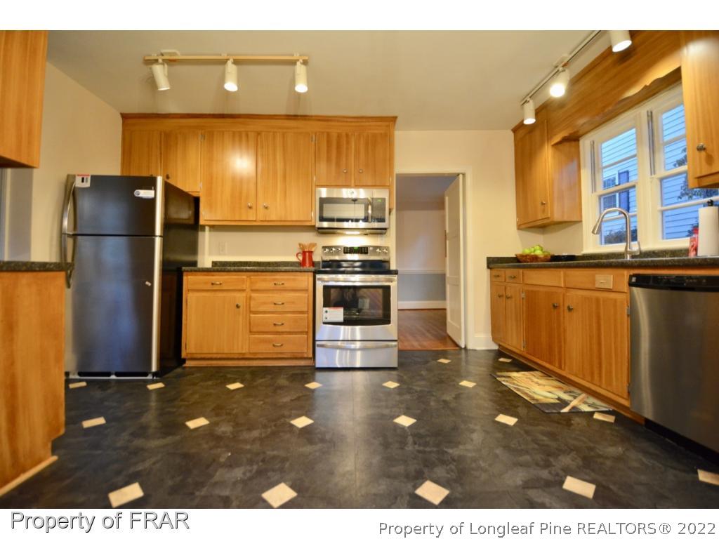 606 Rush Road Fayetteville, NC 28305 - Photo 10 of 22 a kitchen with stainless steel appliances granite countertop a refrigerator and a sink
