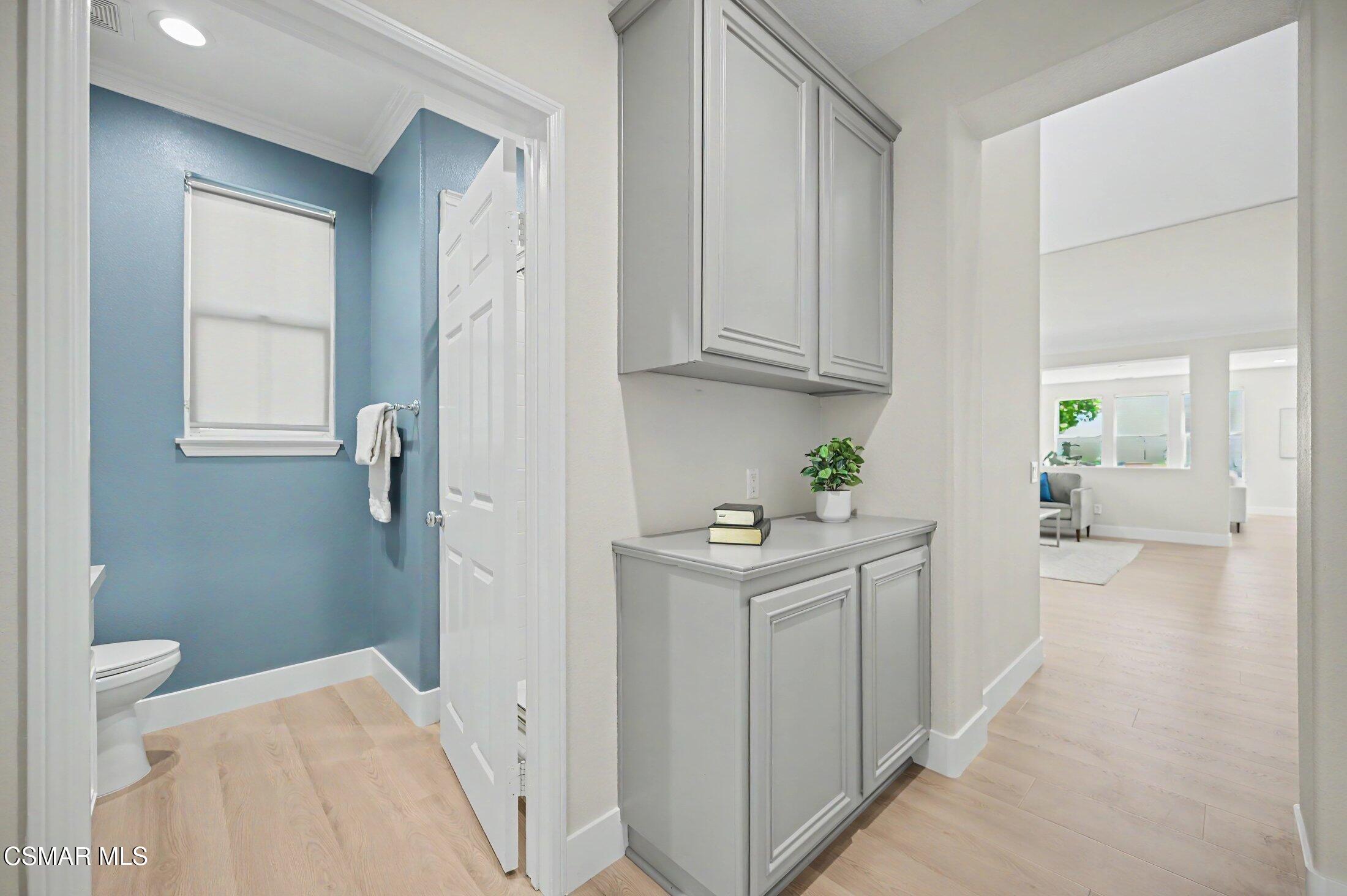 20800 Sardinia Way Porter Ranch, CA 91326 - Photo 21 of 57 a view of a kitchen with white cabinets and wooden floor