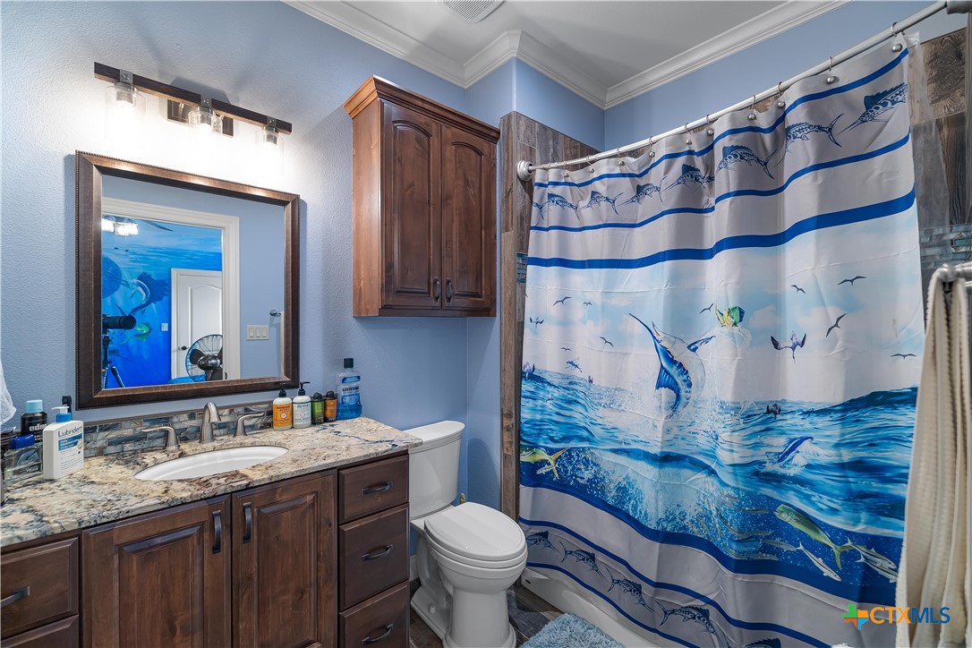 254 Sendera Loop Victoria, TX 77904 - Photo 43 of 48 a bathroom with a granite countertop toilet sink and mirror