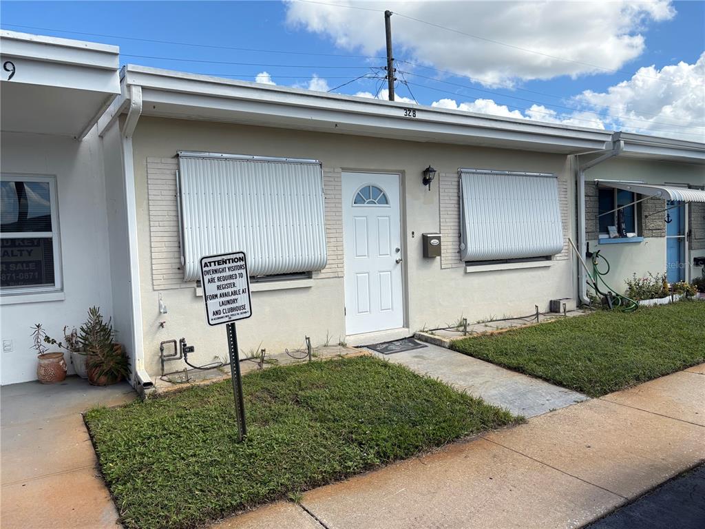 250 Rosery Road Northwest, Unit 328 Largo, FL 33770 - Photo 12 of 17 a front view of a house with garden
