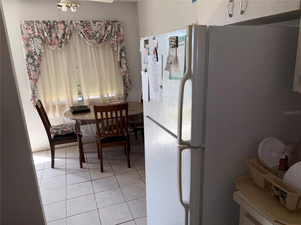 250 Rosery Road Northwest, Unit 328 Largo, FL 33770 - Photo 8 of 17 a dining room with furniture and a window