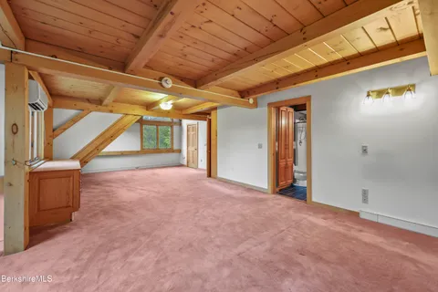 a view of an entryway with wooden floor and windows
