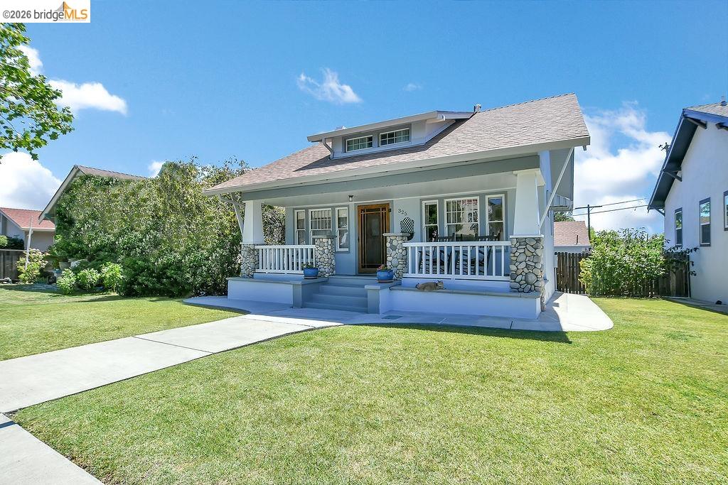 325 South 2nd Street Rio Vista, CA 94571 - Photo 5 of 33 Craftsman-style home featuring a covered front porch, stone column bases, white railing, and a gabled roofline
