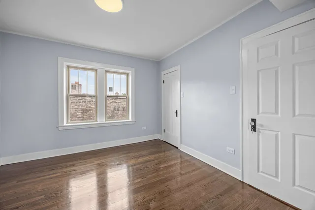 a view of a balcony with wooden floor & fence