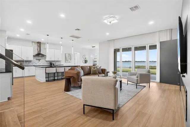 a large kitchen with stainless steel appliances granite countertop a lot of counter space and a sink