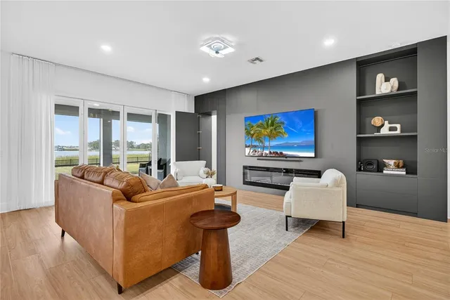 a kitchen with stainless steel appliances granite countertop a sink a counter space and living room view
