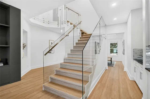 a kitchen with granite countertop a sink cabinets stainless steel appliances and a counter top space