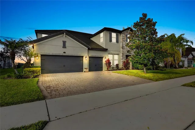 a dining room with wooden floor a chandelier a glass table and chairs
