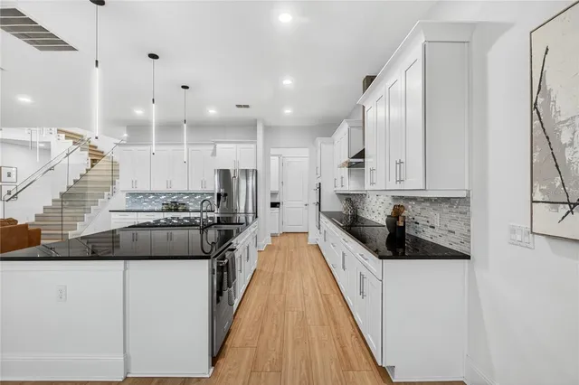 a bathroom with a double vanity sink a toilet and mirror