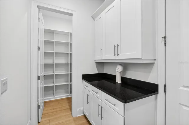 a kitchen with granite countertop a sink and a wooden floor