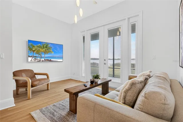 a view of a hallway with wooden floor and staircase