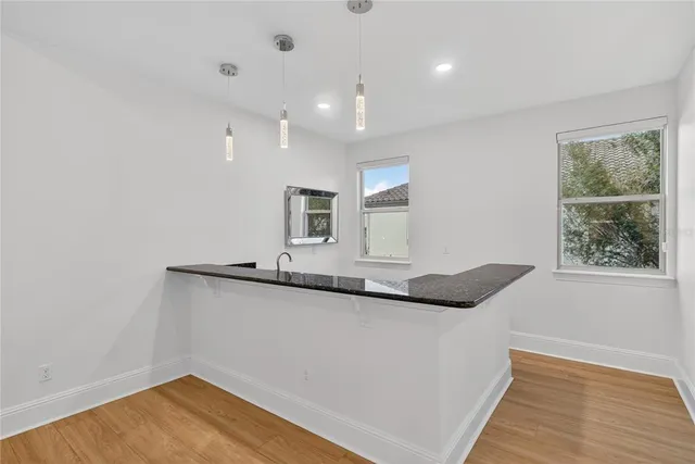 a view of a house with a big yard and large trees