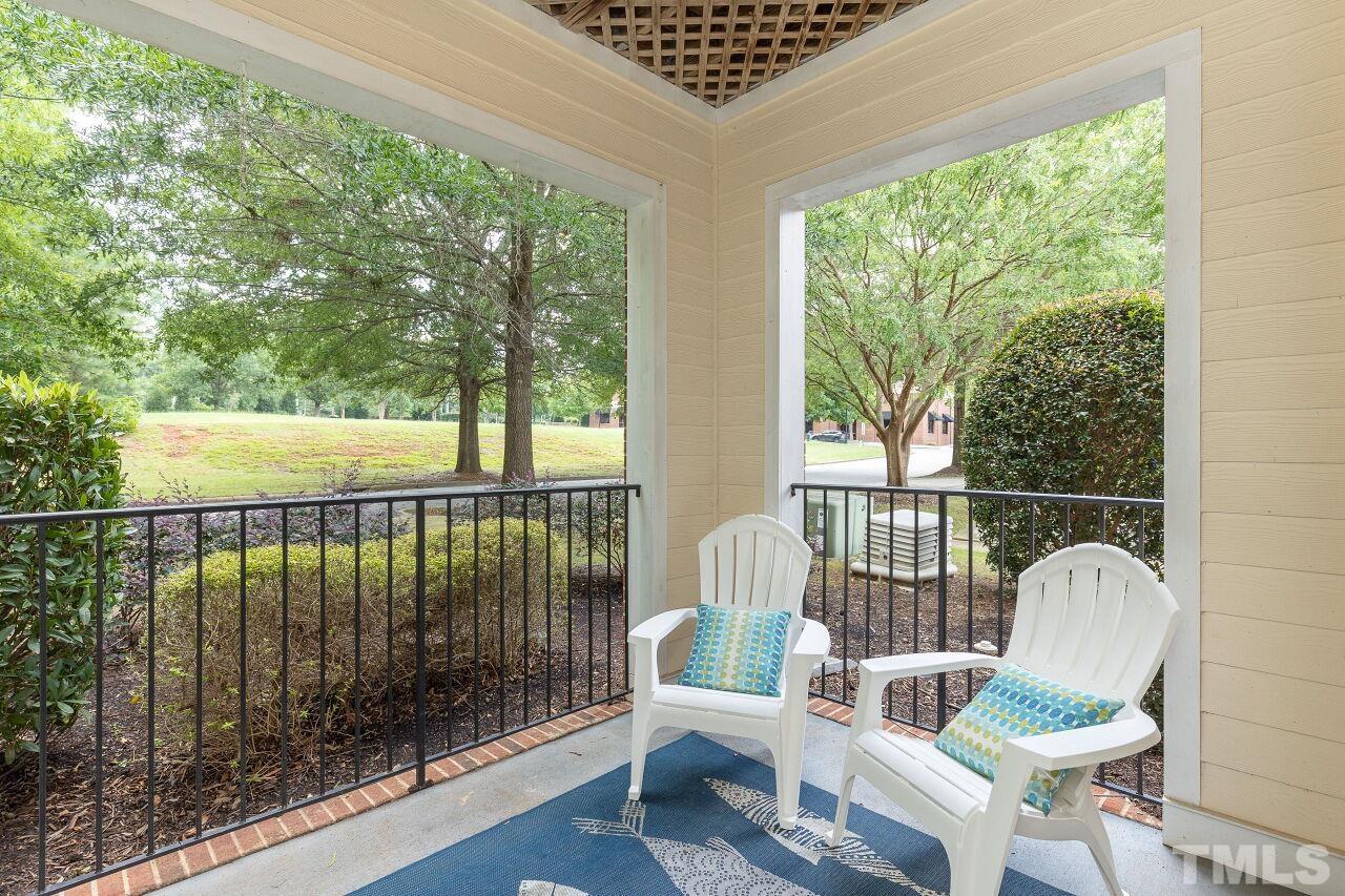 208 West Savannah Ridge Road, Unit 208 Holly Springs, NC 27540 - Photo 18 of 30 a view of a chair and table in the balcony