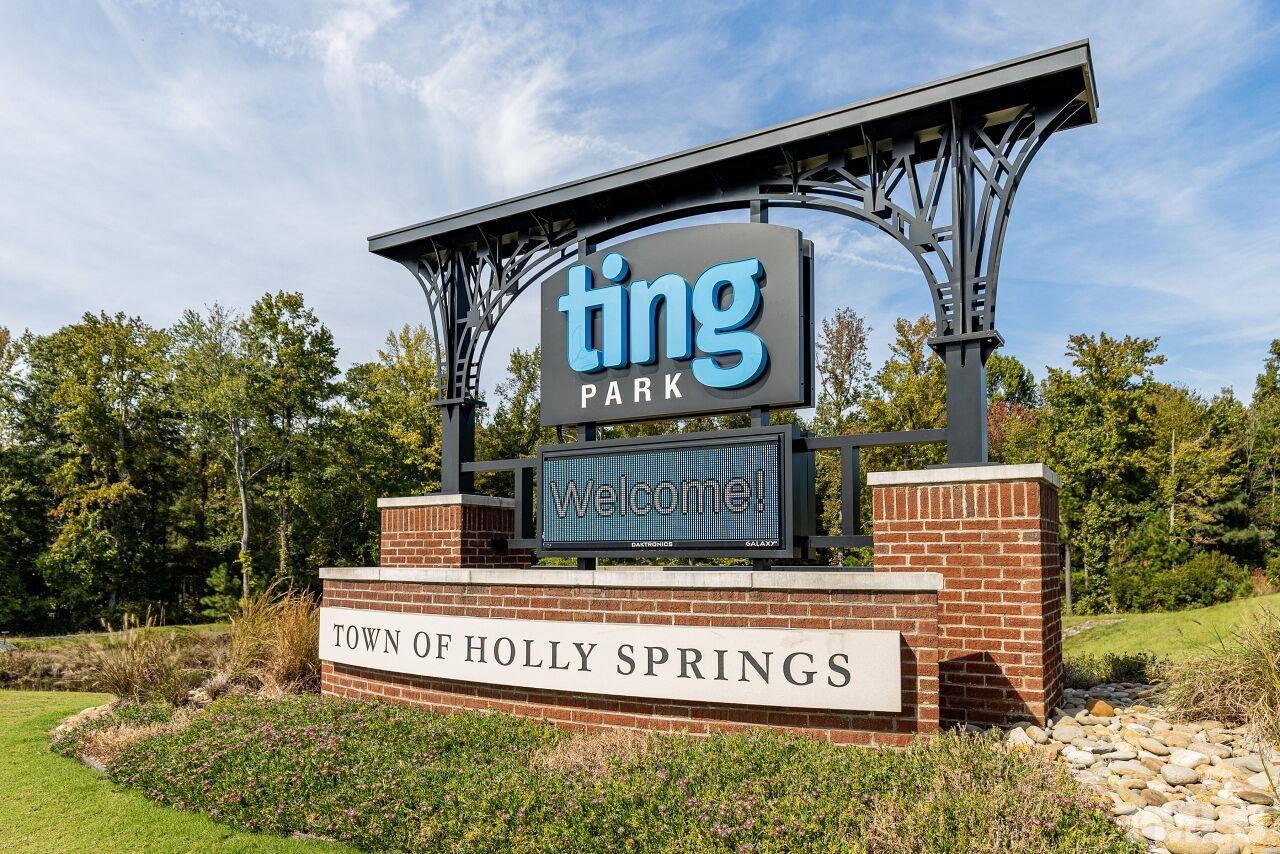 208 West Savannah Ridge Road, Unit 208 Holly Springs, NC 27540 - Photo 27 of 30 a sign on the side of a building